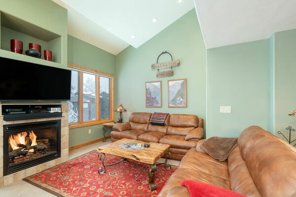 The leather couches, fireplace, and flat-screen TV of this 2 bedroom condo in Telluride.