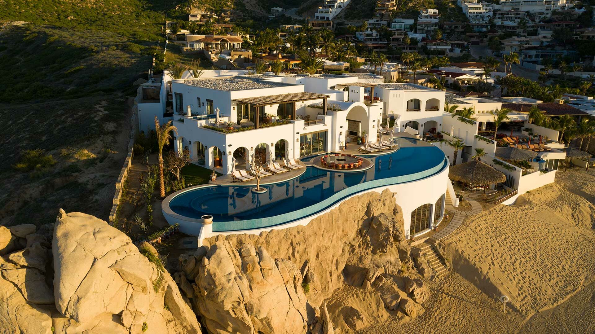 The front exterior of La Datcha, one of our luxury Los Cabos Beachfront villas, as seen from the air.