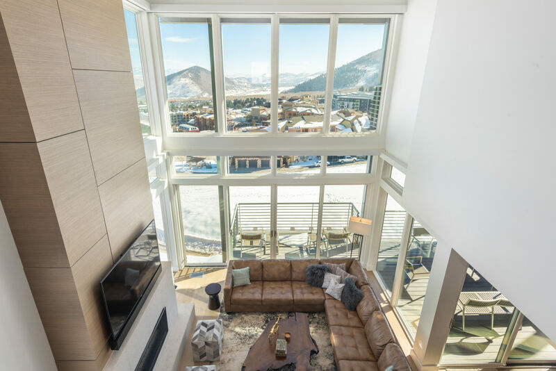 Living room with floor to ceiling windows.