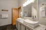 Main Level Shared Bath with double sinks, tub/shower combo, and private laundry units