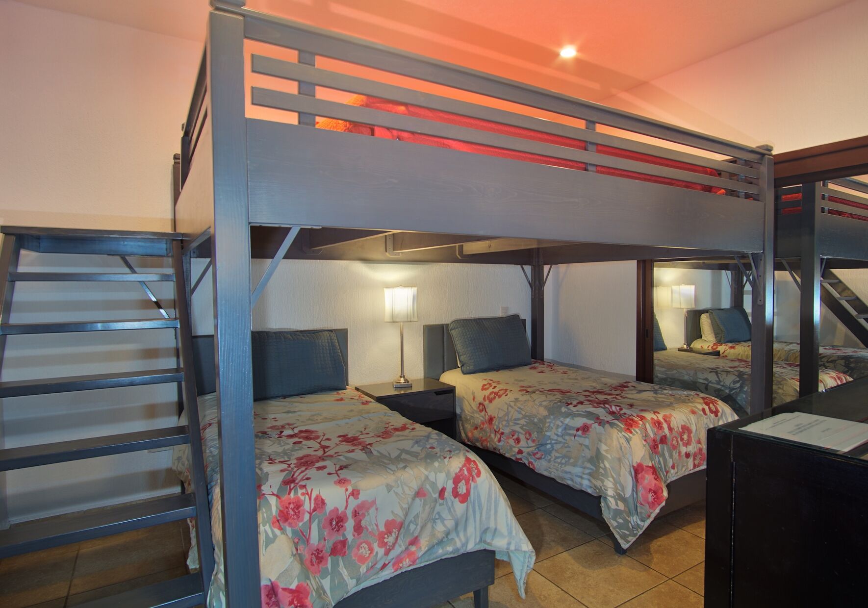 THe guest bedroom has a custom bunk bed with 2 twin beds, and a large king bed above.
