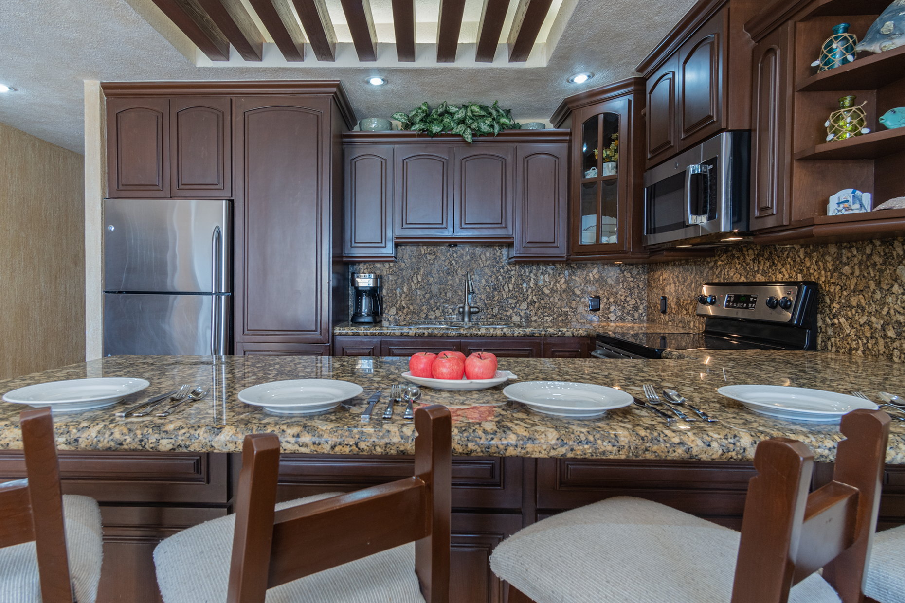 The charming kitchen with visas overhead and fine wooden cabinets.