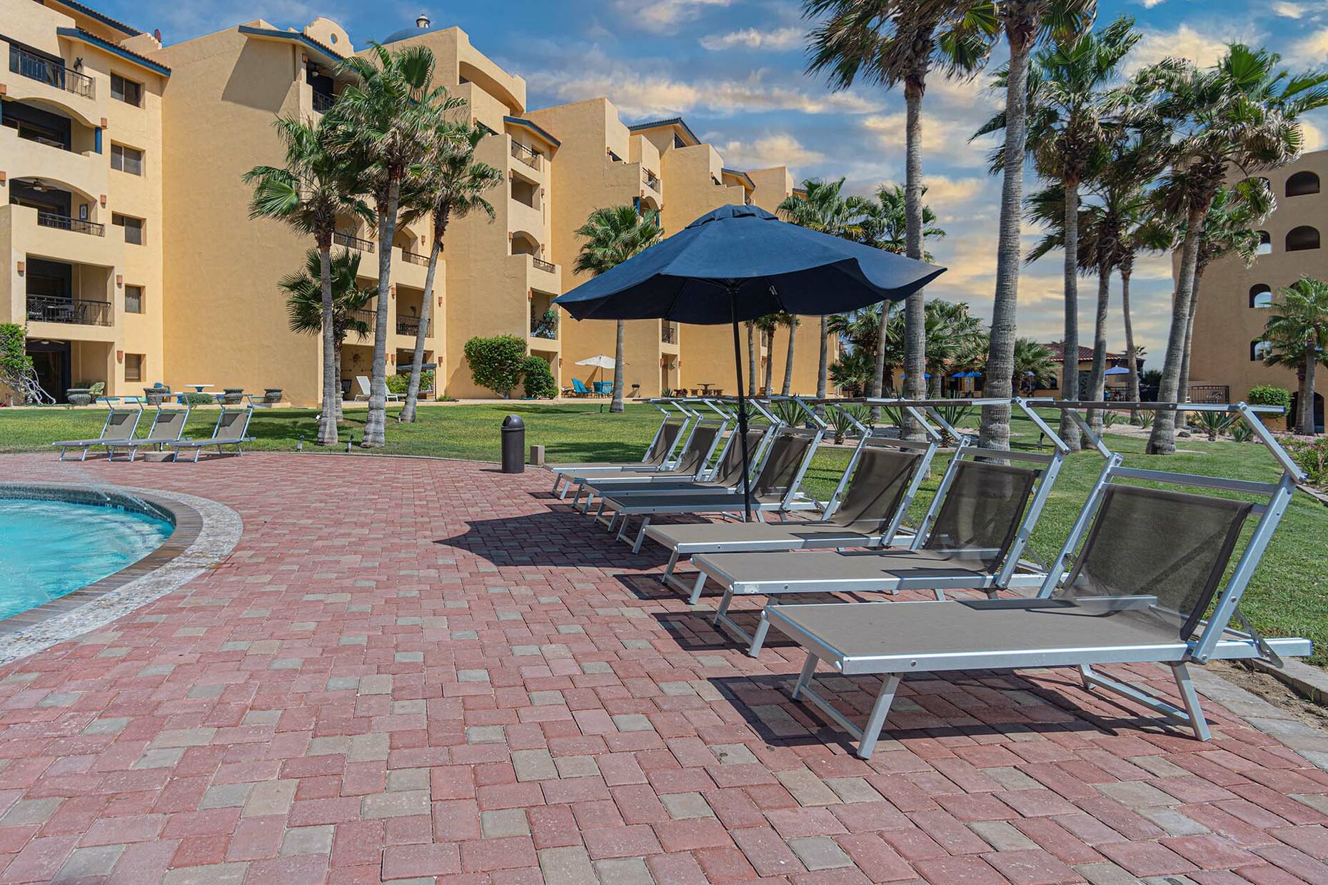 Chaise lounges by the pool outside of the unit.