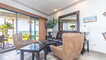 Two swivel chairs and a leather sofa in the living groom.