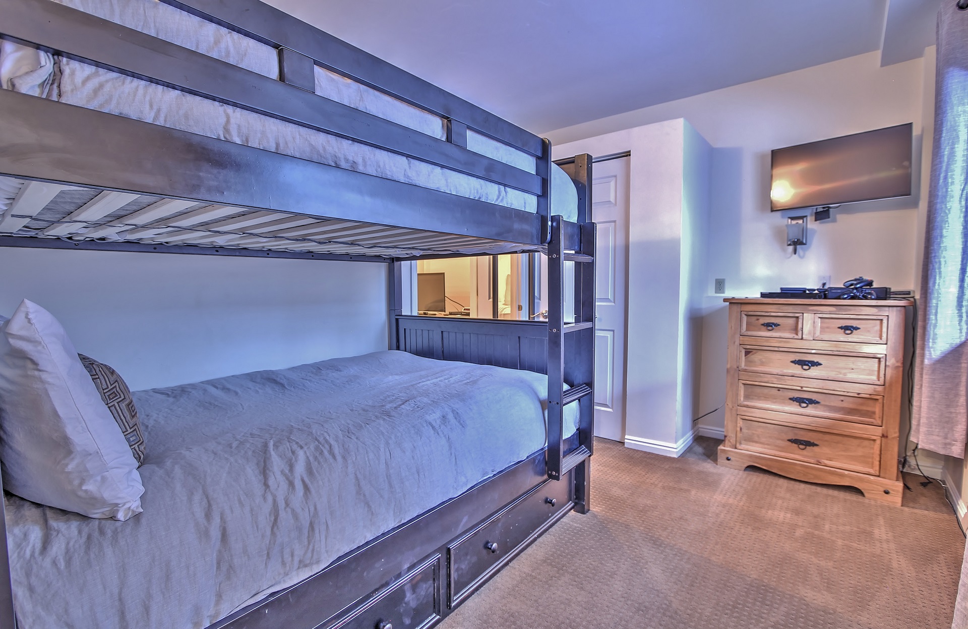 Second bedroom with two full beds, a twin trundle bed, and 32