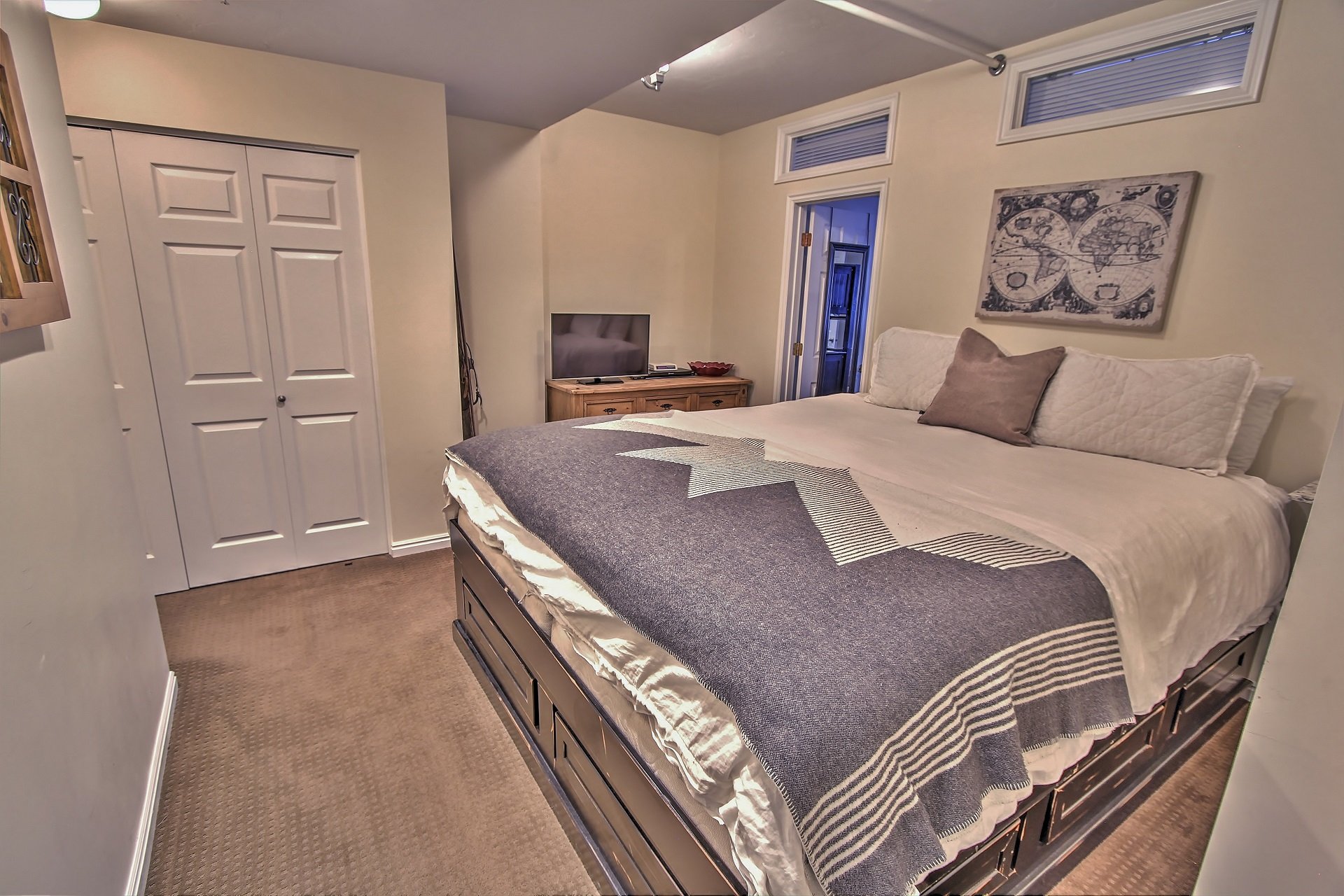 View of master bedroom with NBA king bed, private bathroom, and 32