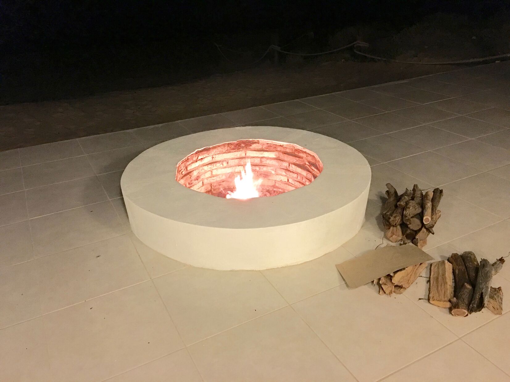 The fire pit at night on the ocean front patio