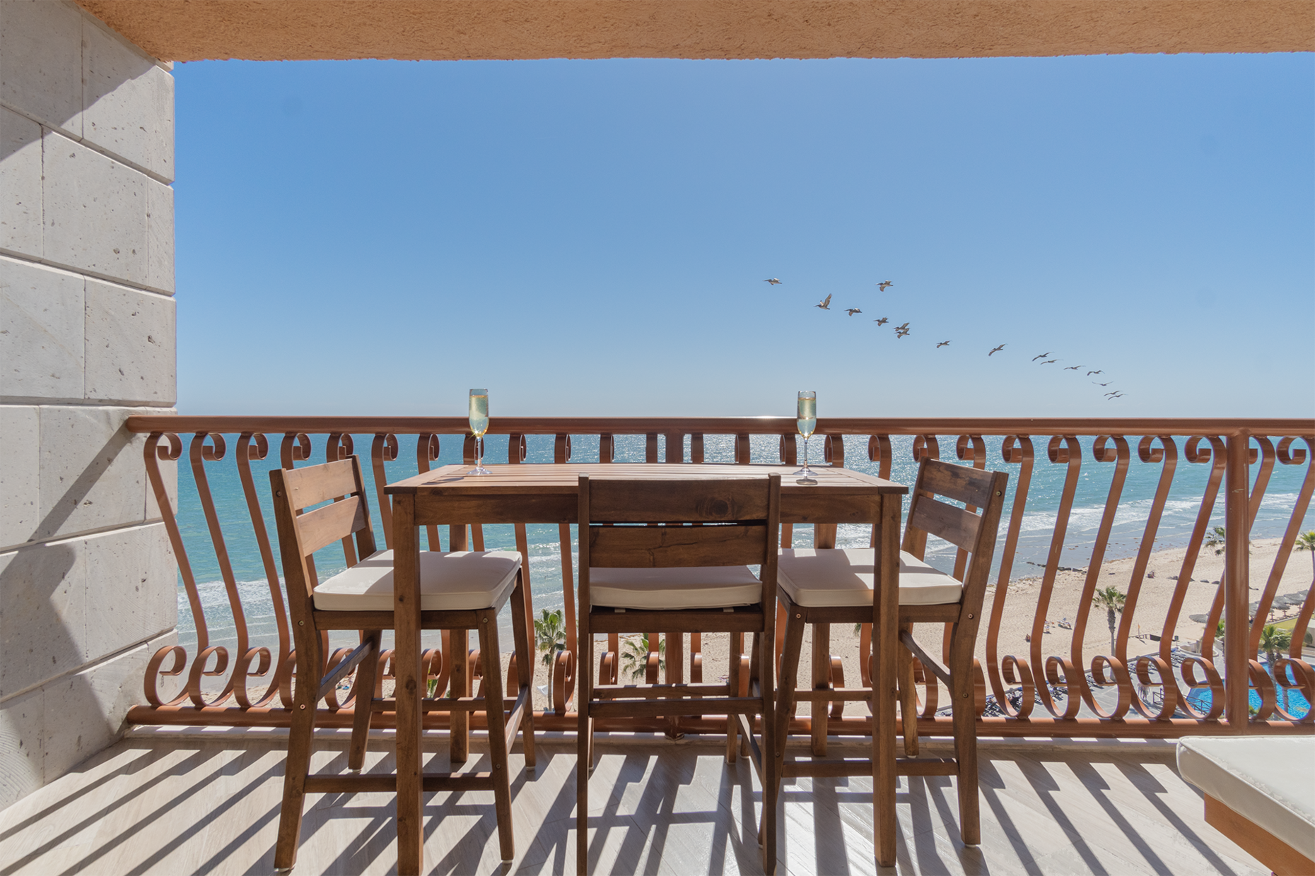 Birds fly by as you enjoy the beach from up above.