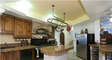 gourmet kitchen with huge stove with 2 ovens, coffee bar, and 2 refrigerators