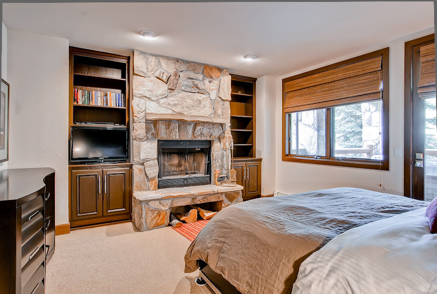 Master bedroom with gas fireplace and access to deck in Mont Cervin 101 - Deer Vally