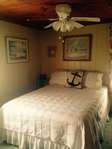 Master bedroom - beautifully carpeted and appointed.  Air conditioner and ceiling fan.