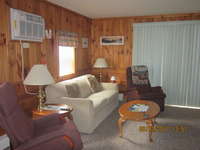 Air Conditioned Living Room has a comfortable couch and two recliners to enjoy while watching TV.