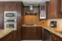 The kitchen features rich granite and cabinetry.
