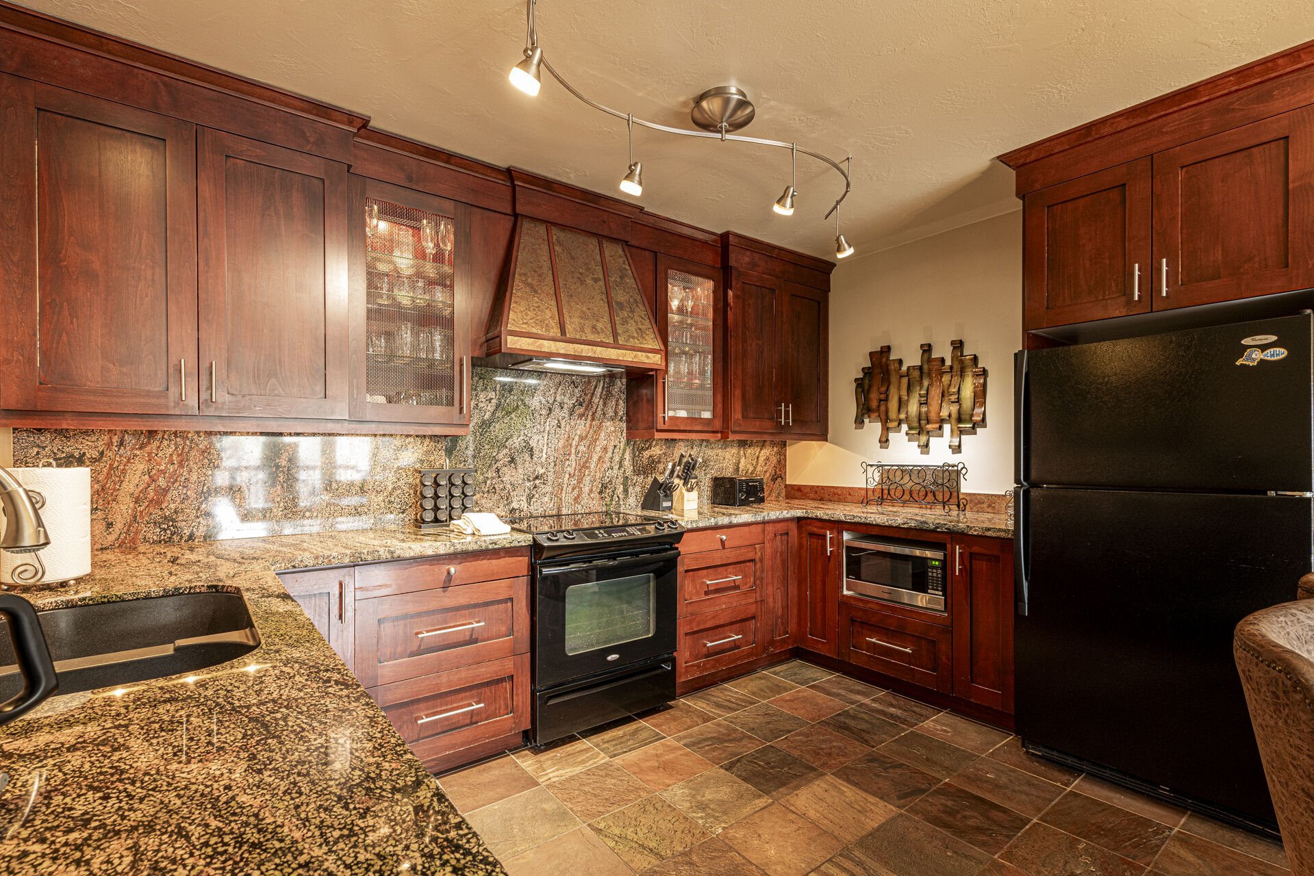 Fully equipped kitchen with rich wood finishes Fully equipped kitchen with rich wood finishes