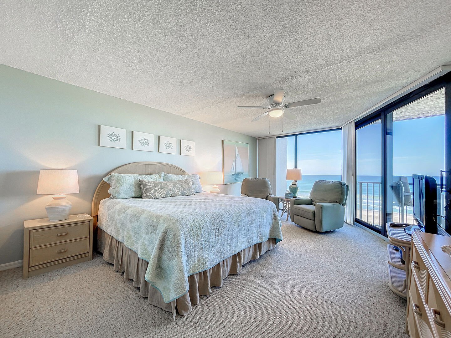 Wake up and see the dolphins play in the oceanfront master bedroom with floor-to-ceiling windows, king sized bed, flat screen TV, DVD and private master bath.