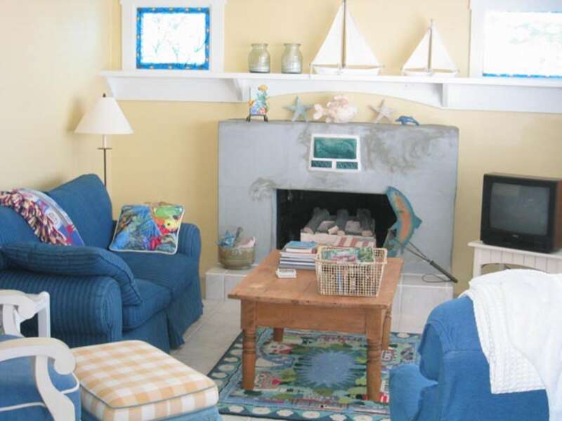 Oceanfront living room with sofa sleeper, relciner, TV, DVD, VCR, and gas fireplace.