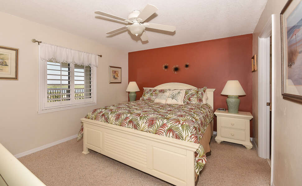 Spacious master bedroom with king size bed and river views.