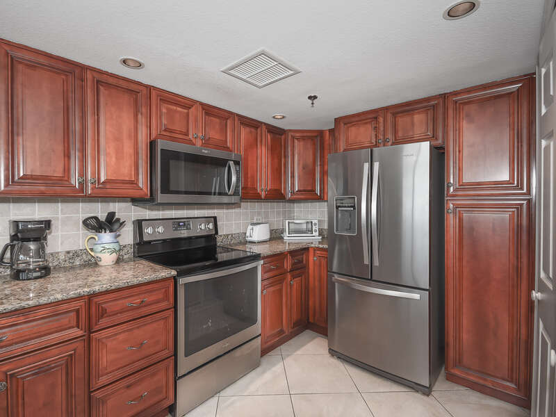 Updated, fully equipped kitchen with updated appliances and granite counter tops.