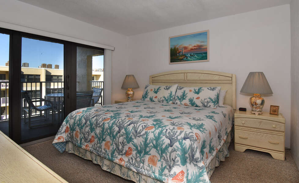 Bedroom with King Size Bed, TV and Ocean View Balcony Access at New Smyrna Beach Condo Rental