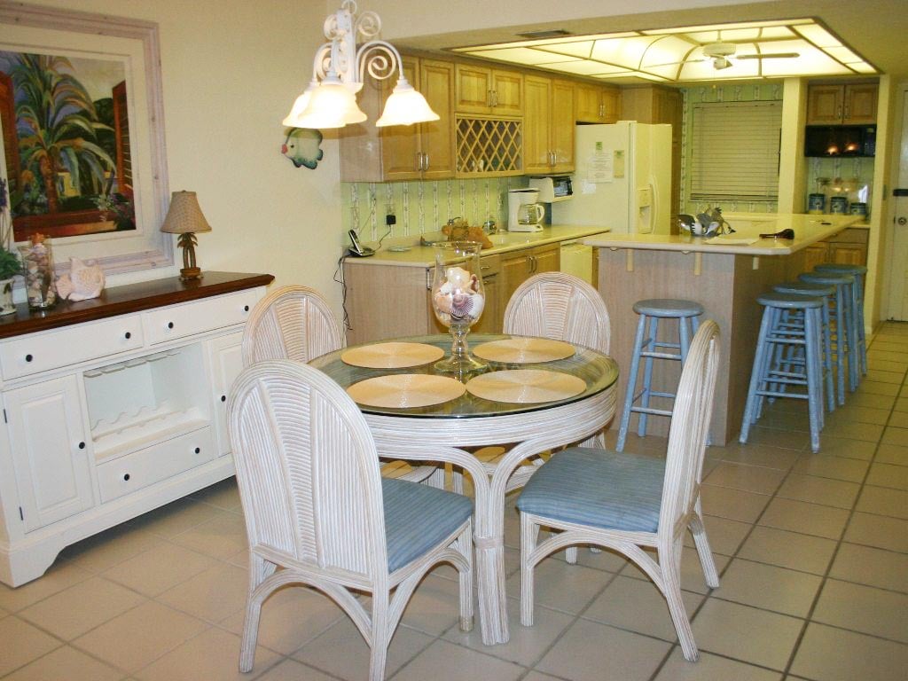 Ocean view dining room with additional seating at the kitchen counter.