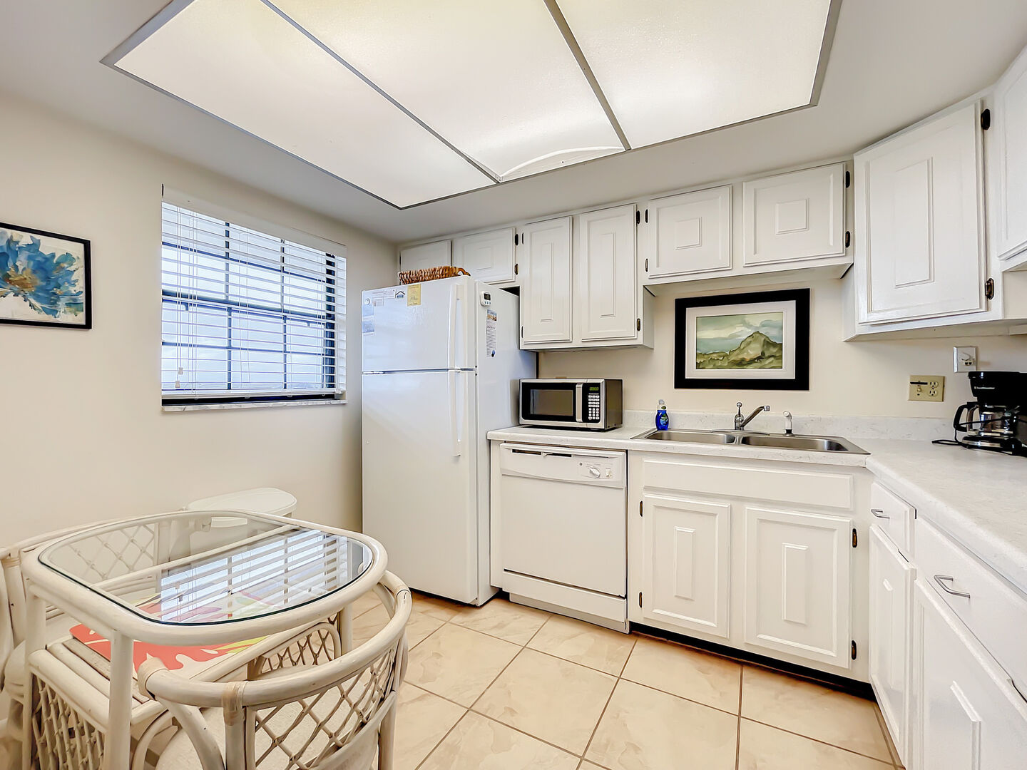 Full Kitchen with White Cabinet, Appliances, and Sky light