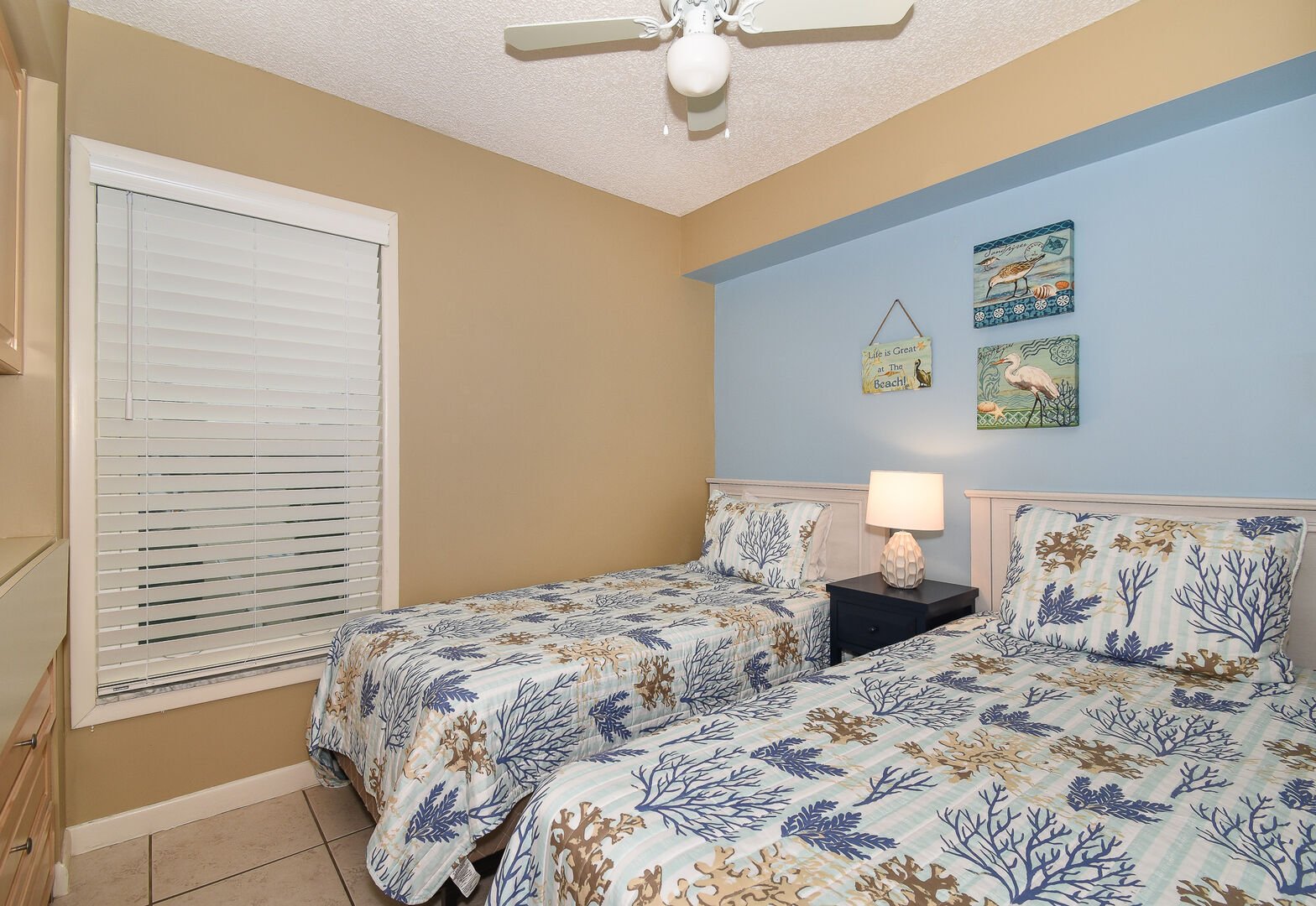Bedroom with Two Twin Beds and Reef Themed Decor at New Smyrna Beach Vacation Rentals