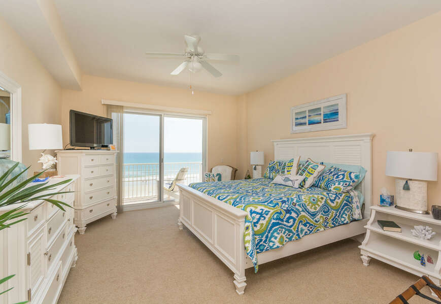Oceanfront master bedroom with king size bed, TV, access the oceanfront balcony and private master bath.