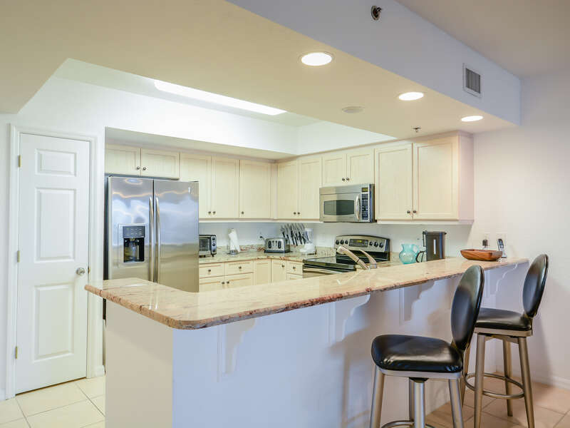 Fully Equipped Kitchen with Granite Counter Tops and Stainless Steel Appliances.