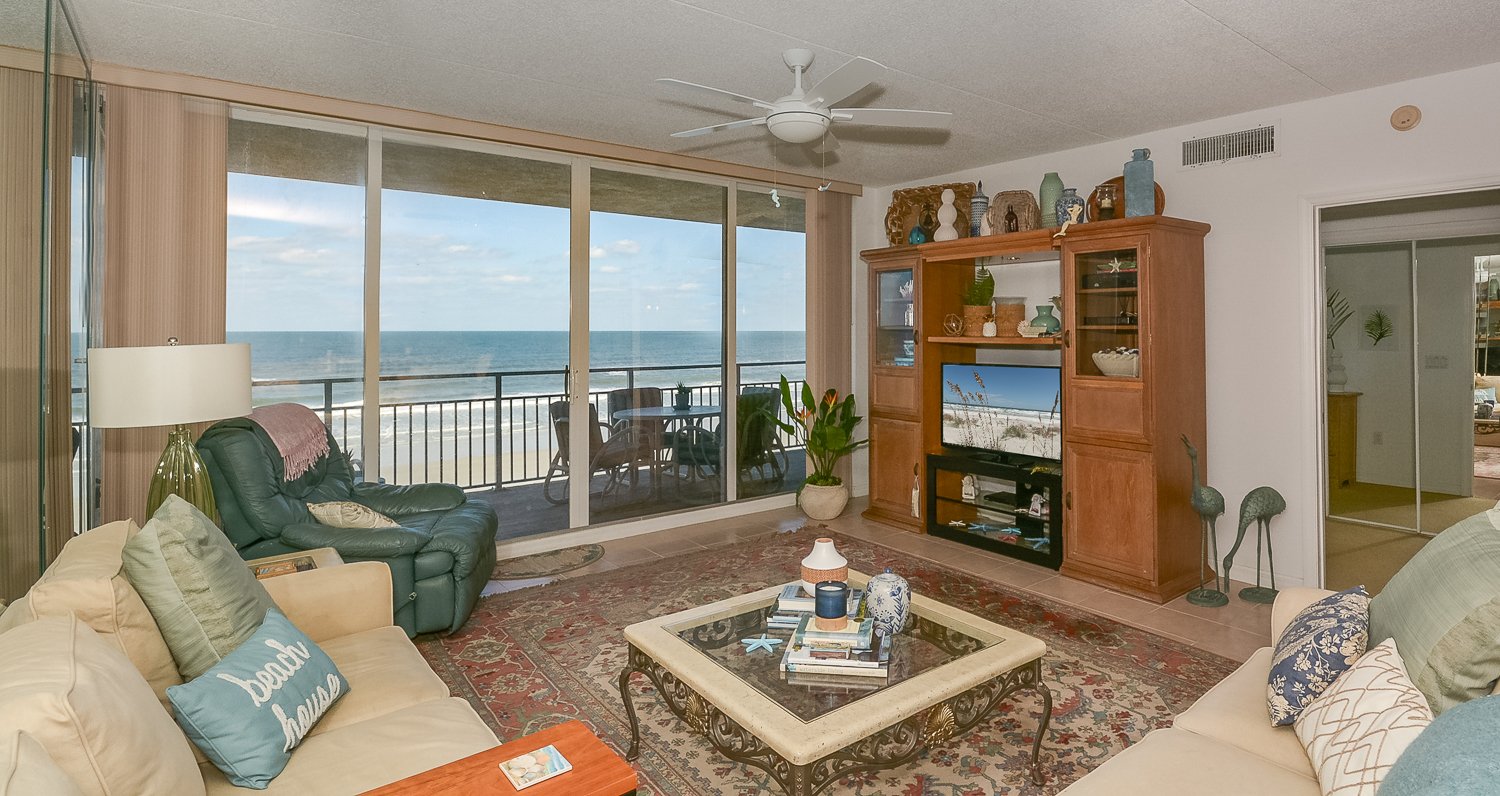 Oceanfront living room with big screen TV and DVD player.