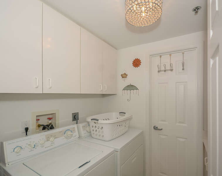 Laundry room with full sized washer/dryer.