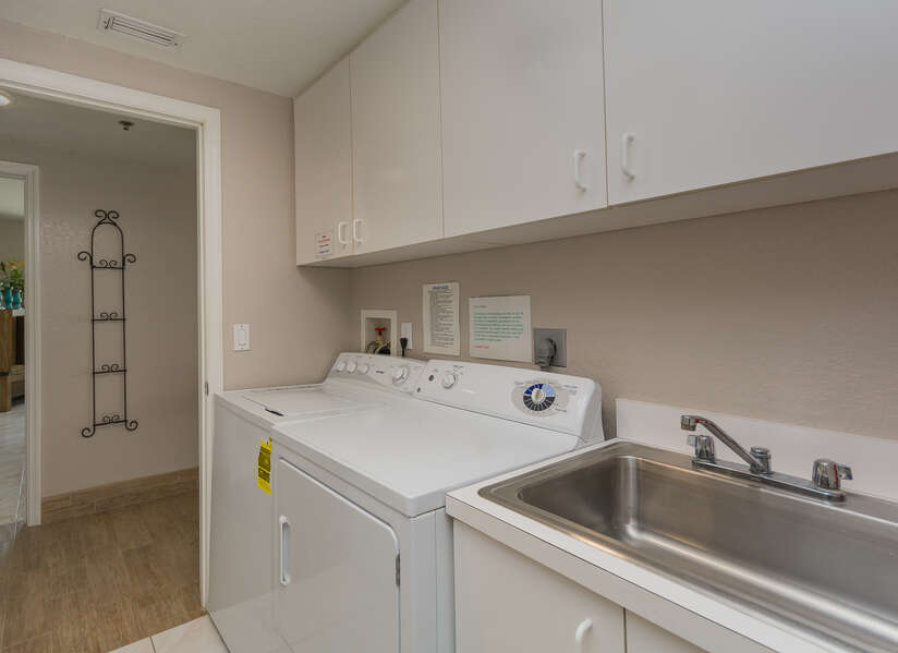 Laundry room with full size washer/dryer.