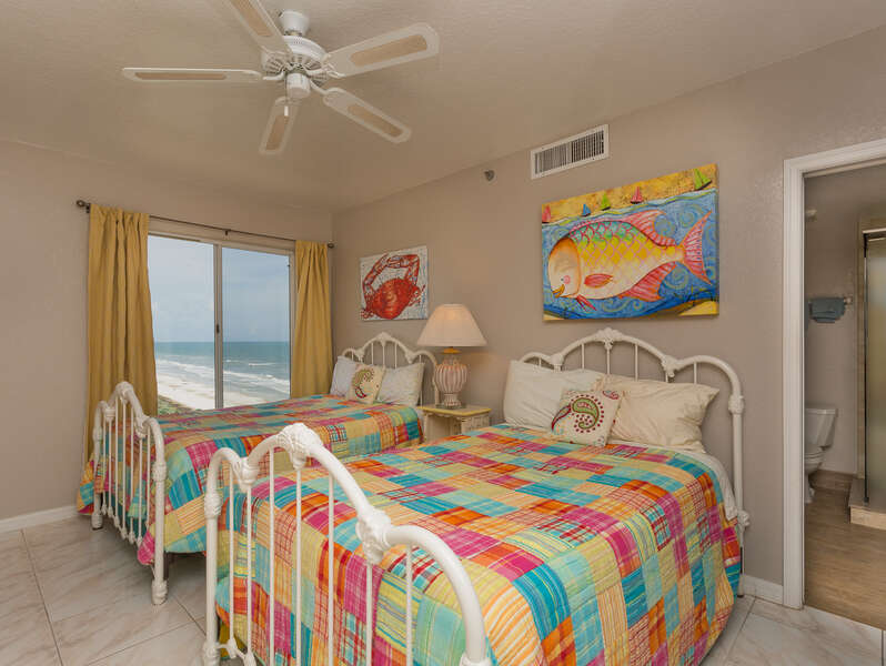 Ocean view 2nd bedroom with 2 queen size beds, TV and private bath.