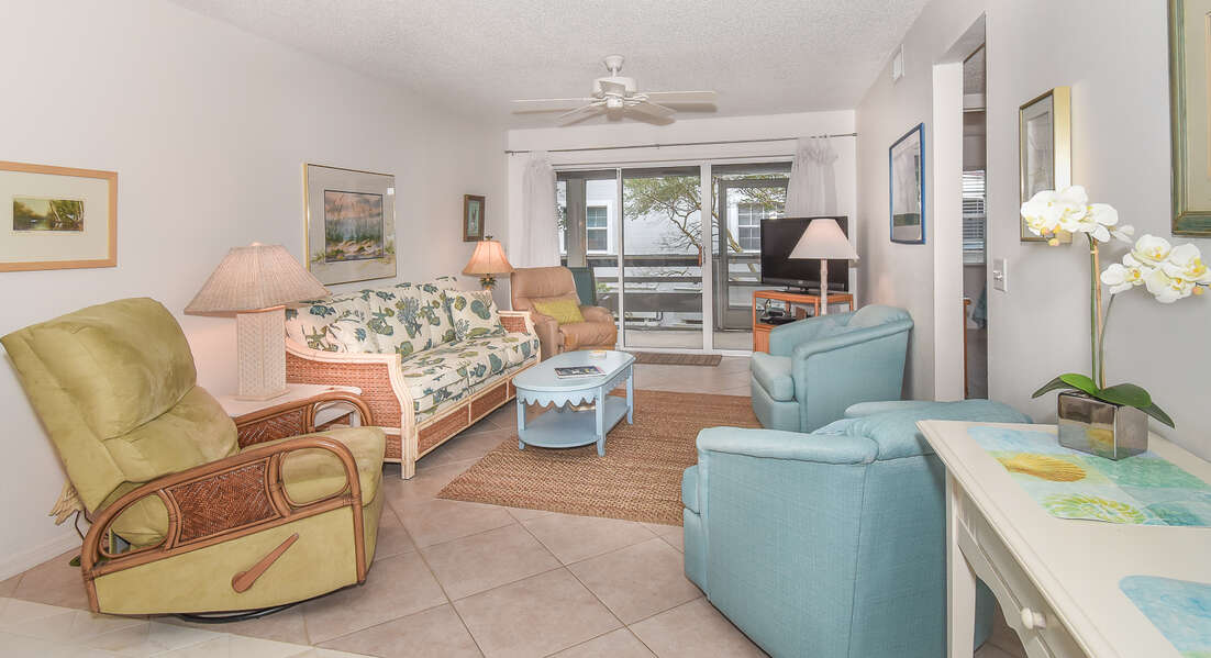 This New Smyrna Beach vacation home features a living room with TV, DVD, sofa and recliner.