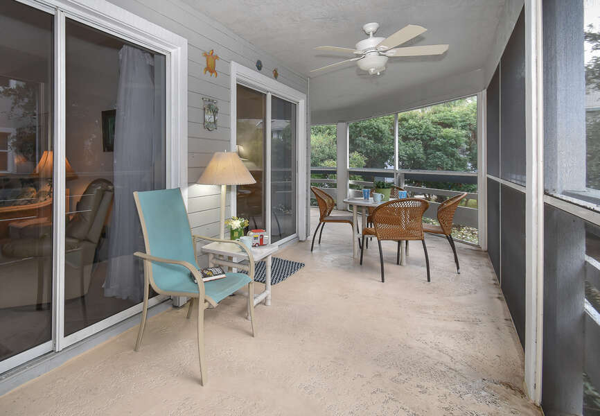 Screened in porch outside this New Smyrna Beach vacation home.