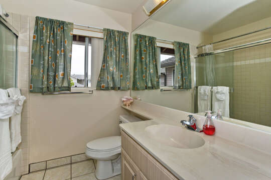 Large Bathroom Features Sink, Toilet, and Windows.