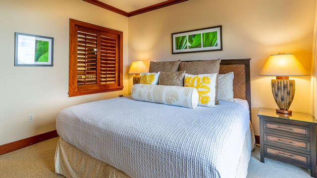 The Master Bedroom has Private Access to the Lanai, alongside large bed, dresser, and wall-mounted TV.