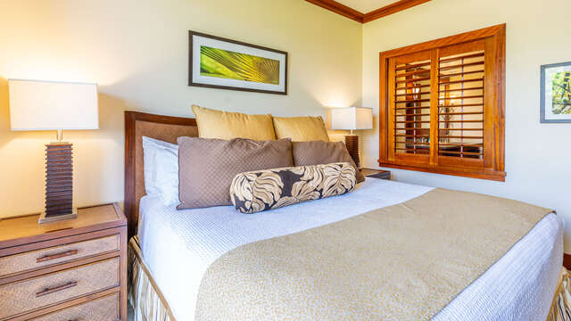 Master Bedroom with King Bed and access to Lanai. Includes view into master bathroom through slatted windows