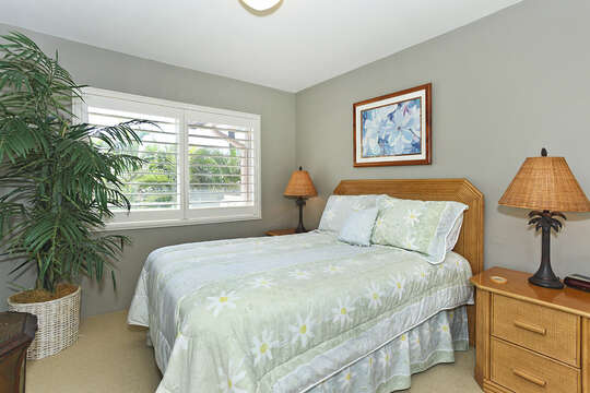 Second Bedroom Features Large Bed and Two Side Table.