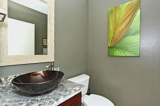 Half Bath with Beautiful Sink and Mirror Above.