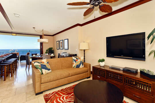 Living Area with TV, Sofa, Coffee Table, Ceiling Fan, and Views of the Ocean.