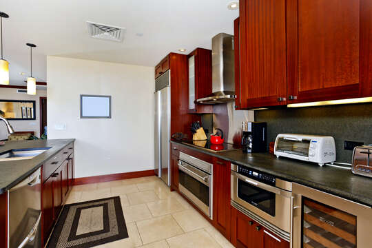 Kitchen with Island, Refrigerator, Stove, Oven, Coffee Maker, Wine Cooler, and Dishwasher.