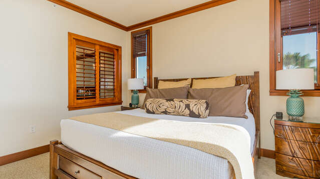 Master Bedroom with King Bed, access to Lanai, and wooden slat window of the master bathroom