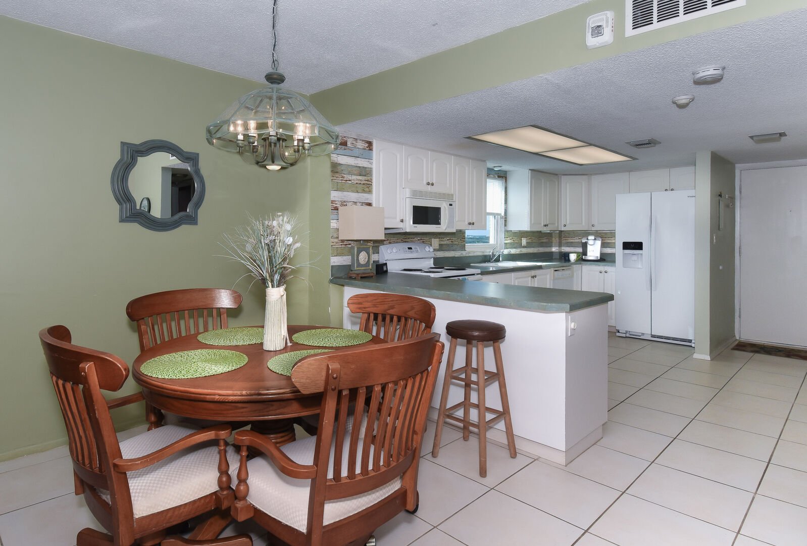 Dining area and kitchen of this private condo in New Smyrna Beach.