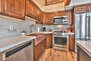 Renovated Fully Equipped Kitchen with Quartz Counters, Stainless Steel Appliances, and Hardwood Floors Throughout
