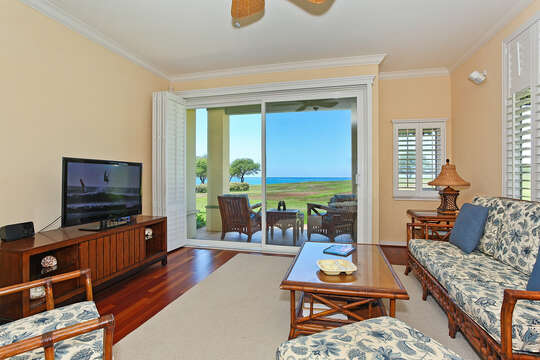 Living Area with Ocean View, couches, coffee table, and TV on entertainment center.