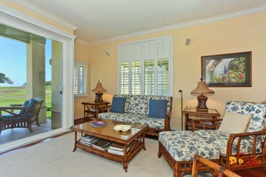 Comfortable Living Area with island-themed seating, coffee table, and side tables with lamps supplying ample lighting.