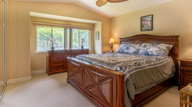 Large Master Bedroom with Ceiling Fan and TV.
