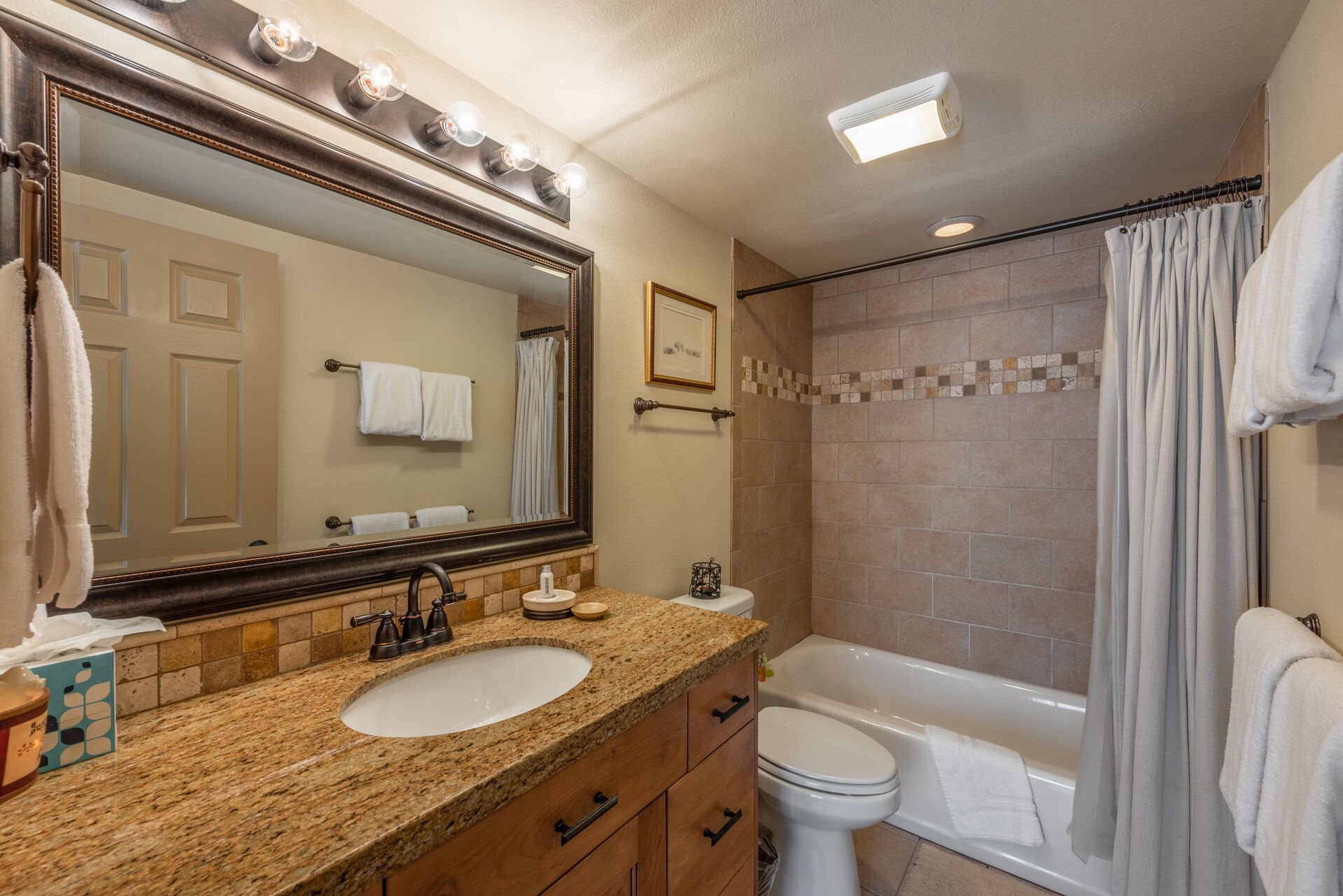 Upper Level Full Shared Bath with a Granite Countertop Vanity and a Tub/Shower Combo