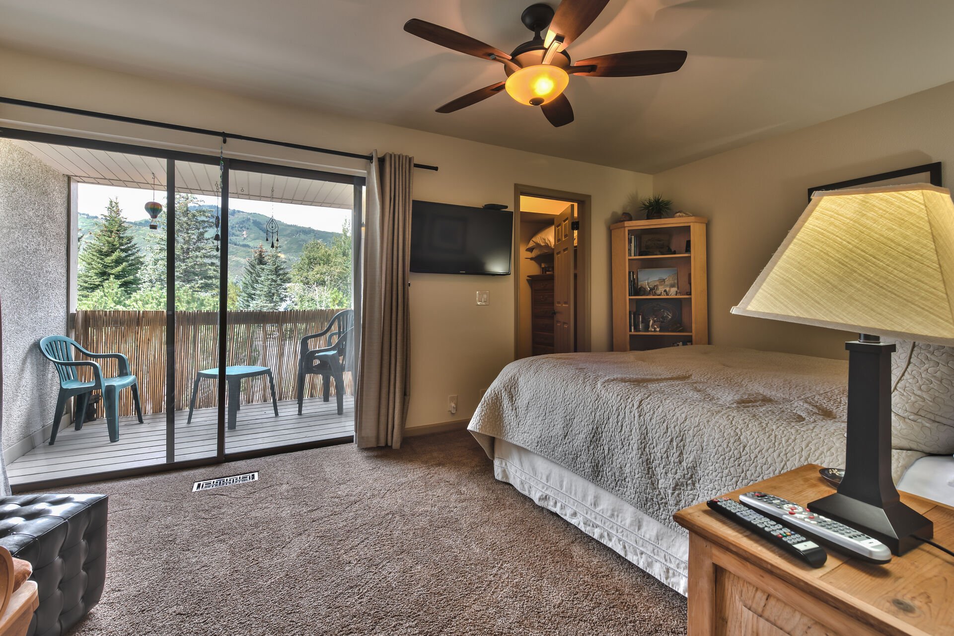 Upper Level Master Bedroom with King Bed, LCD Flat Screen TV, Electric Fireplace, Walk-in Closet, and a Private Deck with Mountain Views