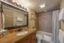 Upper Level Full Shared Bath with a Granite Countertop Vanity and a Tub/Shower Combo